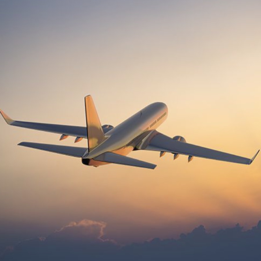 An airplane in flight, representing the reach of telehealth