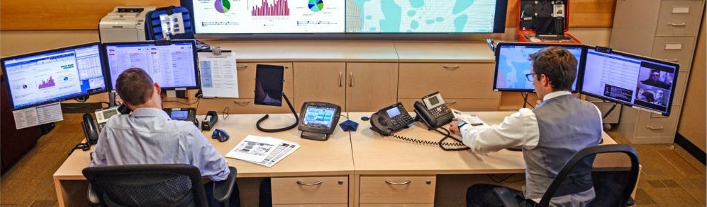 A telehealth command center with clinicians monitoring multiple screens